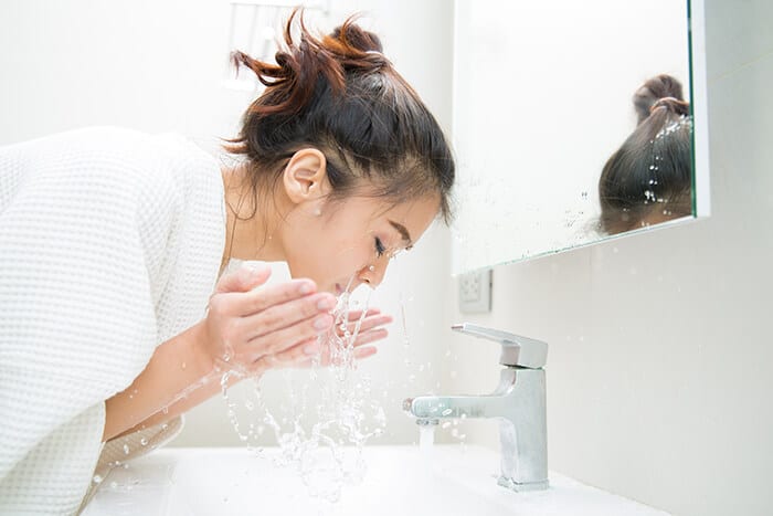 Woman washing her face